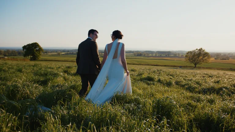 Bride and groom enjoying a quiet countryside moment during sunset